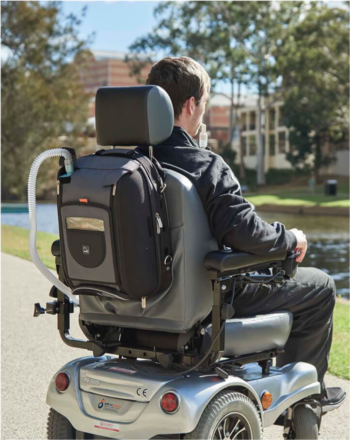 ventilation-traveling-with-a-ventilator-man-in-motorized-wheelchair-using-ventilation