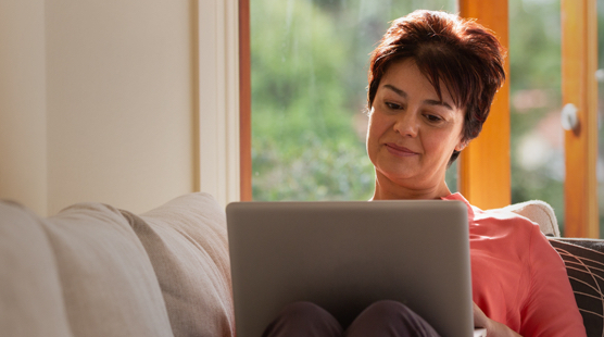 sleep-apnea-global-woman-on-couch-with-laptop